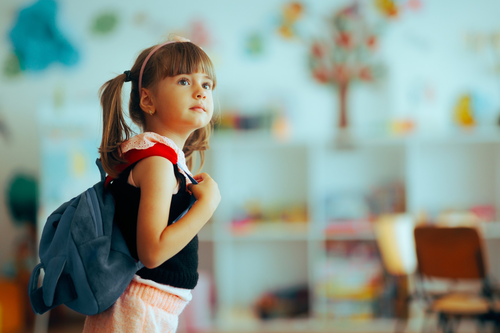 Happy Girl Wearing a Backpack Going Back to Preschool
